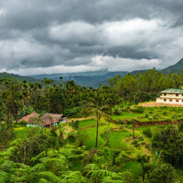 house at remote village isolated with mountain coverd clouds and green forest image is showing the amazing beauty and art of nature. This image is taken at karnataka india.